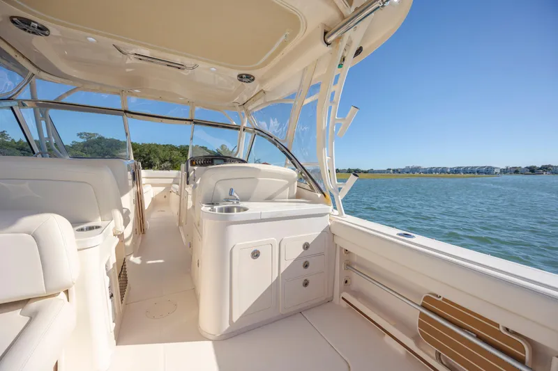 Slide: The Image of 2020 Grady-White Freedom 307 boat interior with seating and water view. - 38
