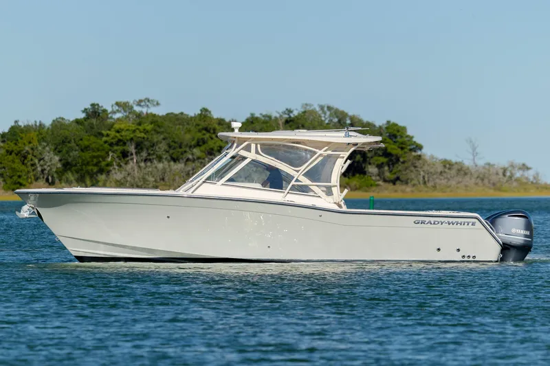 Slide: The Image of 2020 Grady-White Freedom 307 boat on calm water with scenic background. - 5
