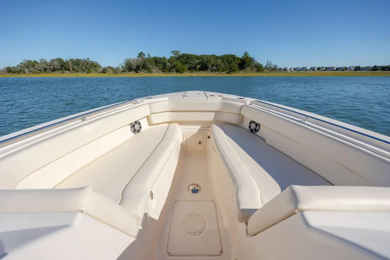 Slide: The Image of 2020 Grady-White Freedom 307 boat interior with spacious seating on calm water. - 9