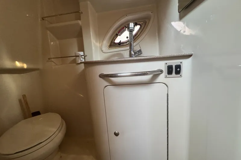 Slide: The Image of 2007 Sea Ray Sundancer 310 bathroom with sink, toilet, and porthole window. - 18