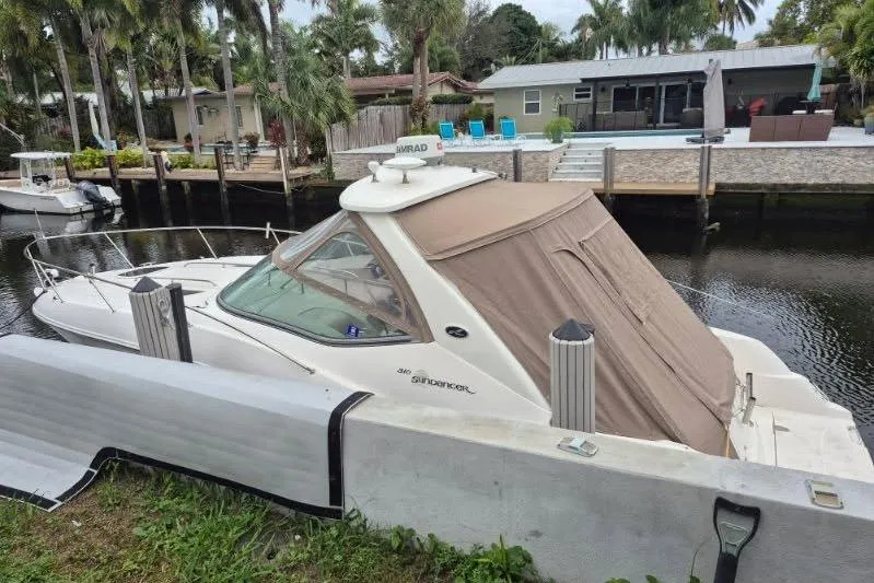Slide: The Image of 2007 Sea Ray Sundancer 310 docked by a waterfront home with palm trees. - 26