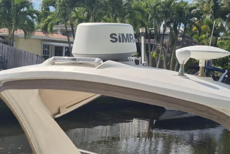Slide: The Image of 2007 Sea Ray Sundancer 310 with Simrad radar, docked near palm trees. - 29