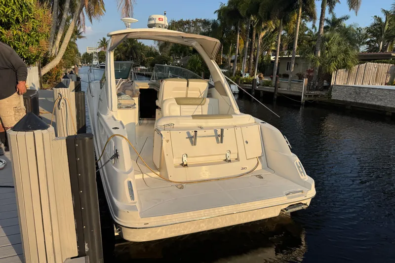 Slide: The Image of 2007 Sea Ray Sundancer 310 docked in a scenic canal with palm trees. - 3