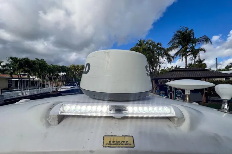 Slide: The Image of 2007 Sea Ray Sundancer 310 boat radar and light against cloudy sky. - 38