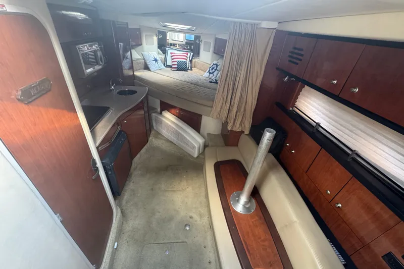 Slide: The Image of 2007 Sea Ray Sundancer 310 interior with kitchenette, seating, and bed. Luxurious boat cabin design. - 39