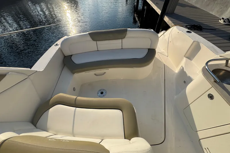 Slide: The Image of 2007 Sea Ray Sundancer 310 boat interior with cushioned seating by the water. - 4