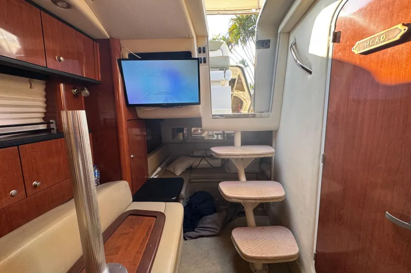 Slide: The Image of Interior of 2007 Sea Ray Sundancer 310 with steps, TV, and wooden cabinetry. - 46