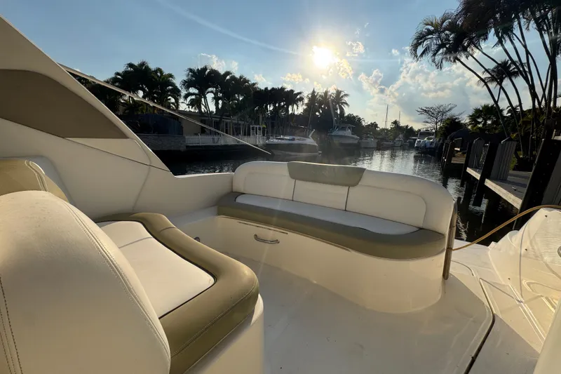 Slide: The Image of 2007 Sea Ray Sundancer 310 boat interior with sunlit seating area by the water. - 5