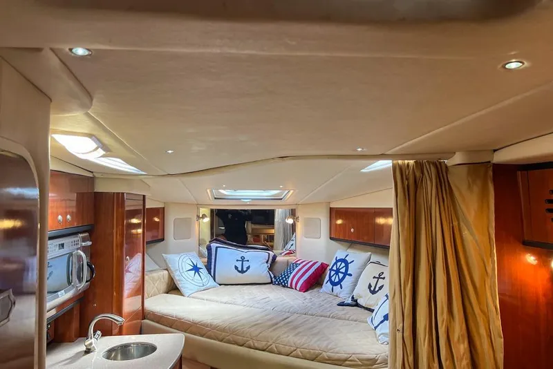 Slide: The Image of 2007 Sea Ray Sundancer 310 cabin interior with nautical-themed decor and modern amenities. - 52