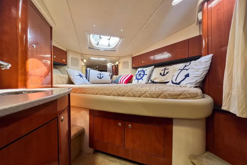 Slide: The Image of Luxurious 2007 Sea Ray Sundancer 310 cabin interior with nautical-themed decor and wood finish. - 57