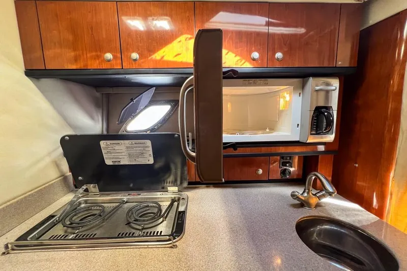 Slide: The Image of 2007 Sea Ray Sundancer 310 galley with stove, microwave, and sink. - 59