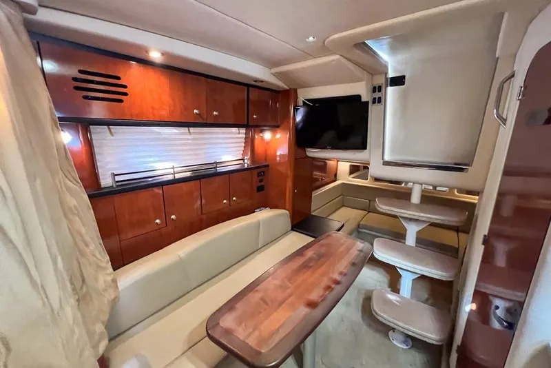 Slide: The Image of Luxurious 2007 Sea Ray Sundancer 310 cabin interior with wood finishes and modern amenities. - 61