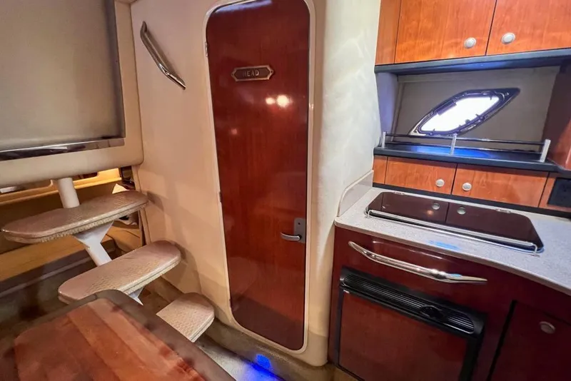 Slide: The Image of Interior of 2007 Sea Ray Sundancer 310 yacht with kitchenette and wooden cabinetry. - 64