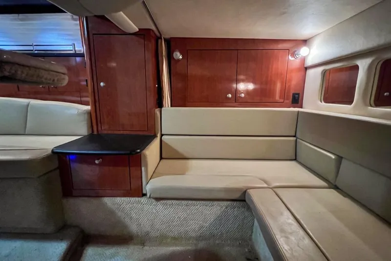 Slide: The Image of Interior of 2007 Sea Ray Sundancer 310 with beige seating and wooden cabinetry. - 65