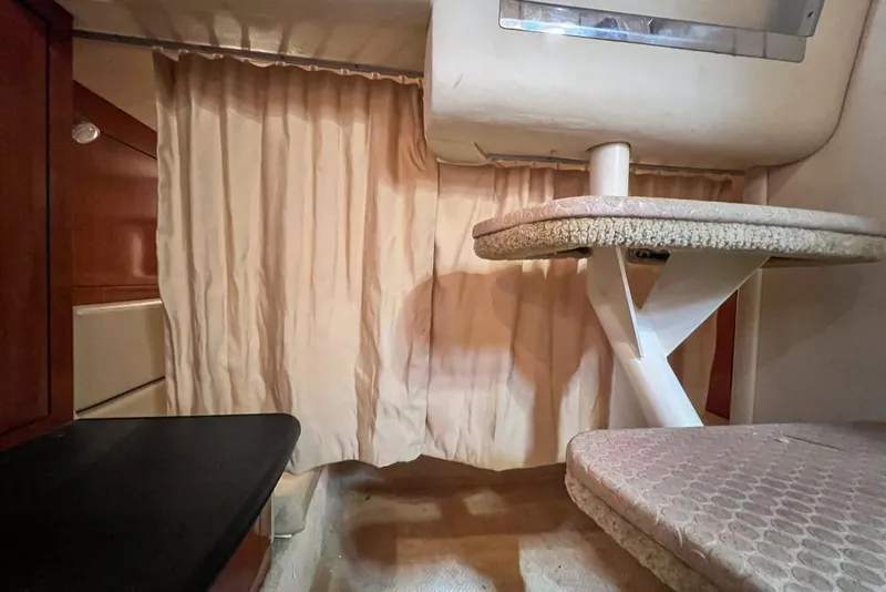Slide: The Image of 2007 Sea Ray Sundancer 310 cabin interior with table and curtain. - 70