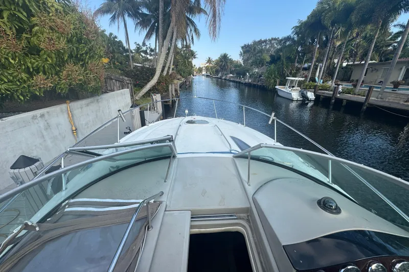 Slide: The Image of 2007 Sea Ray Sundancer 310 yacht docked in a tropical canal setting. - 8