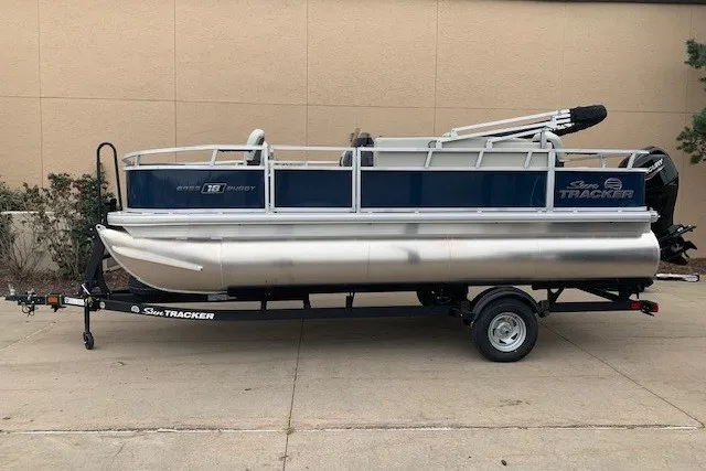 The Image of 2026 Sun Tracker Bass Buggy 18 DLX pontoon boat on trailer, side view. - 0