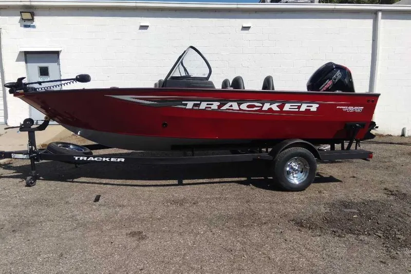 The Image of 2026 Tracker Pro Guide V-175 Combo boat on trailer, red exterior, parked outdoors. - 0