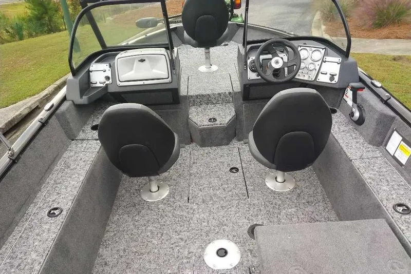 Slide: The Image of 2026 Tracker Pro Guide V-175 Combo boat interior with dual seats and steering console. - 2