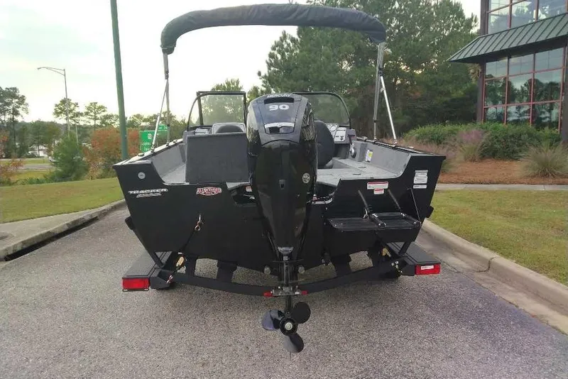 Slide: The Image of 2026 Tracker Pro Guide V-175 Combo boat with outboard motor, parked outdoors. - 3