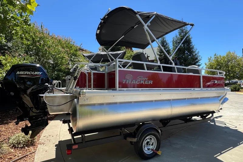 Slide: The Image of 2026 Sun Tracker Bass Buggy 18 DLX pontoon boat with Mercury engine on trailer. - 3