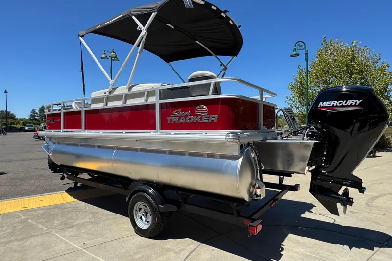 Slide: The Image of 2026 Sun Tracker Bass Buggy 18 DLX pontoon boat with Mercury engine on trailer. - 1