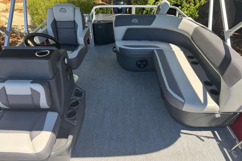 Slide: The Image of 2026 Sun Tracker Bass Buggy 18 DLX interior with gray seating and steering console. - 6