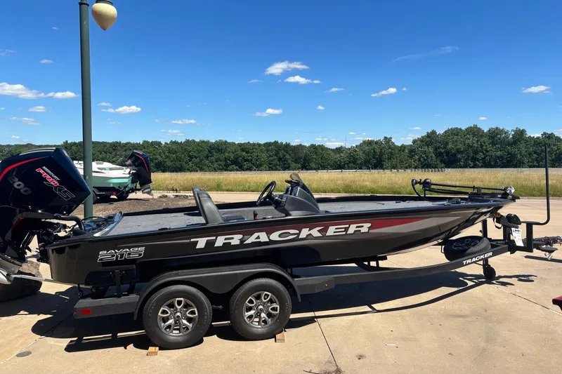 The Image of 2026 Tracker Savage 215 boat on trailer under clear blue sky. - 0