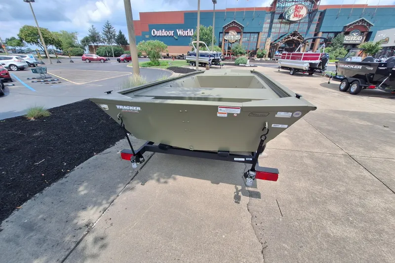 Slide: The Image of 2026 Tracker Grizzly 1648 Utility boat displayed outdoors near Bass Pro Shops. - 4