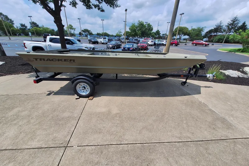 The Image of 2026 Tracker Grizzly 1648 Utility boat on trailer in parking lot. - 0