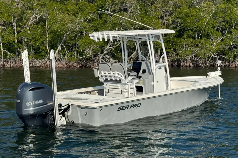 The Image of 2020 Sea Pro 248 Bay boat with Yamaha engine on calm water, surrounded by mangroves. - 1