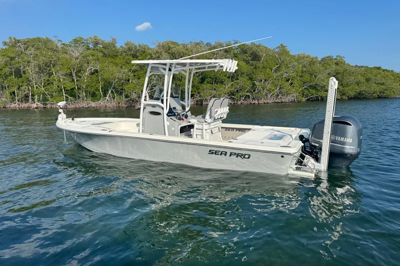 Slide: The Image of 2020 Sea Pro 248 Bay boat on water, surrounded by lush greenery. - 3