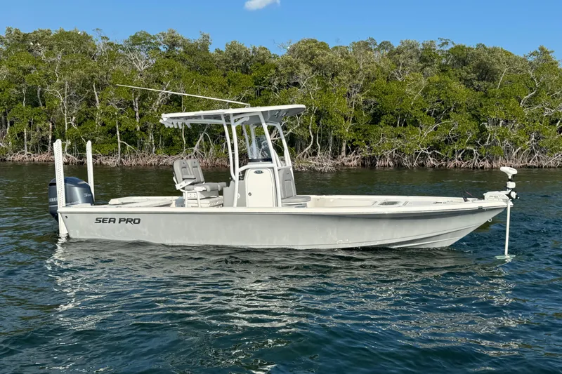 Slide: The Image of 2020 Sea Pro 248 Bay boat on water, surrounded by lush greenery. - 5