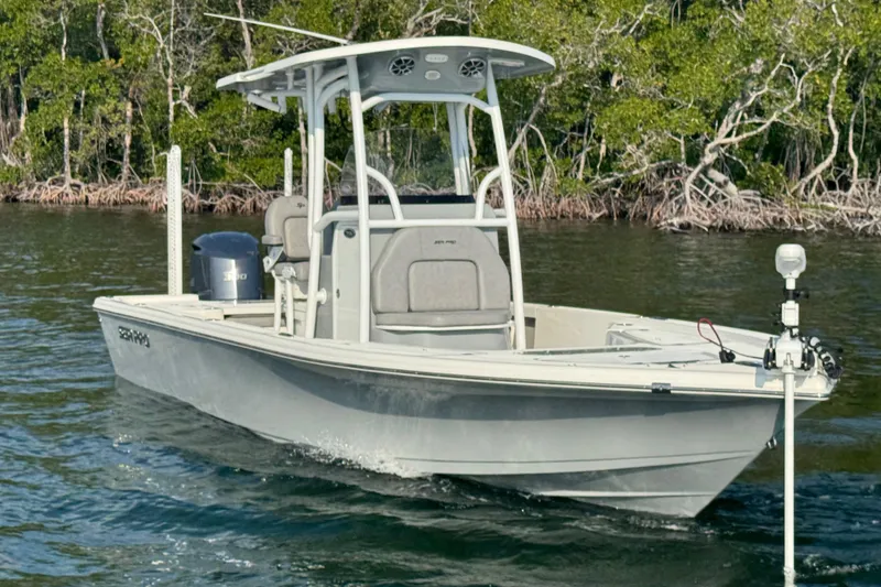 Slide: The Image of 2020 Sea Pro 248 Bay boat on water, surrounded by lush greenery. - 6