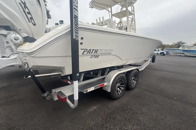 Slide: The Image of 2025 Pathfinder 2700 Open boat on trailer, parked outdoors. - 1
