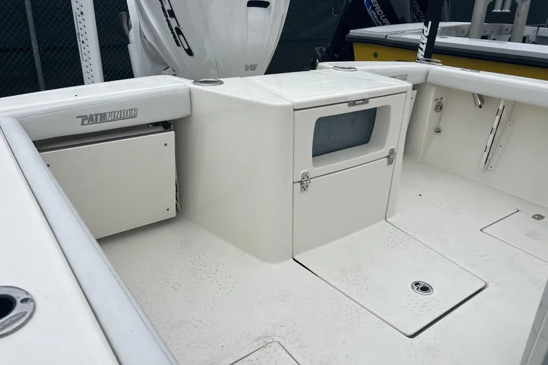 Slide: The Image of 2025 Pathfinder 2700 Open boat interior with storage compartments and seating. - 6
