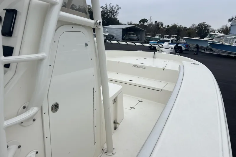Slide: The Image of 2025 Pathfinder 2700 Open boat, white deck, parked in marina with other boats. - 8