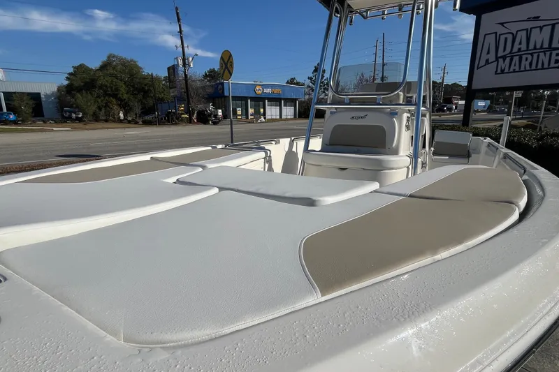 Slide: The Image of 2026 Bulls Bay 2200 boat with cushioned seating, displayed at Adam's Marine dealership. - 17