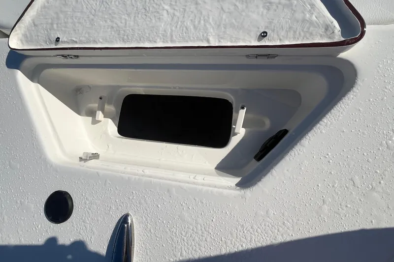 Slide: The Image of Open storage compartment on a 2026 Bulls Bay 2200 boat, with water droplets visible. - 18