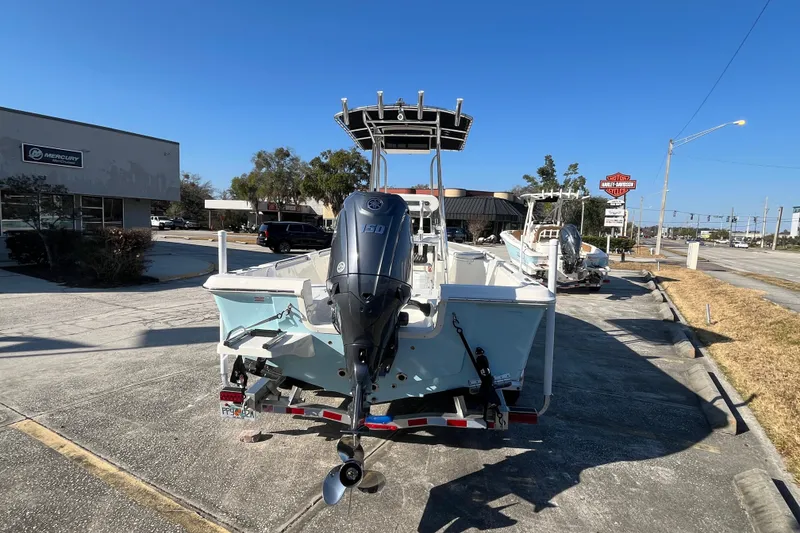 Slide: The Image of 2026 Bulls Bay 2200 boat with outboard motor on trailer, parked near dealership. - 7