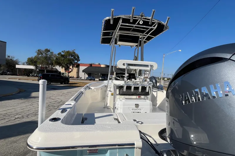 Slide: The Image of 2026 Bulls Bay 2200 boat with Yamaha engine, parked outdoors under clear blue sky. - 9