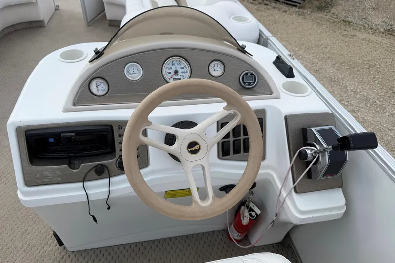 Slide: The Image of Steering console of a 2006 Crest II LE 2270 boat with gauges and controls. - 10