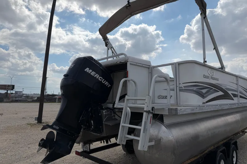 Slide: The Image of 2006 Crest II LE 2270 pontoon boat with Mercury outboard motor under cloudy sky. - 3
