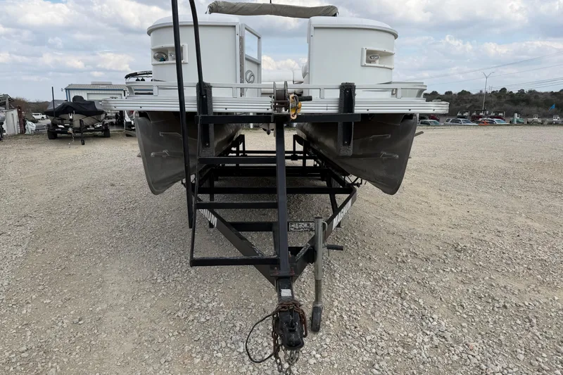Slide: The Image of 2006 Crest II LE 2270 pontoon boat on trailer, parked on gravel lot. - 5
