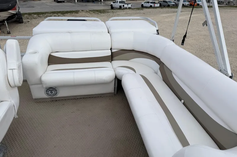 Slide: The Image of 2006 Crest II LE 2270 pontoon boat interior with white and beige seating. - 7