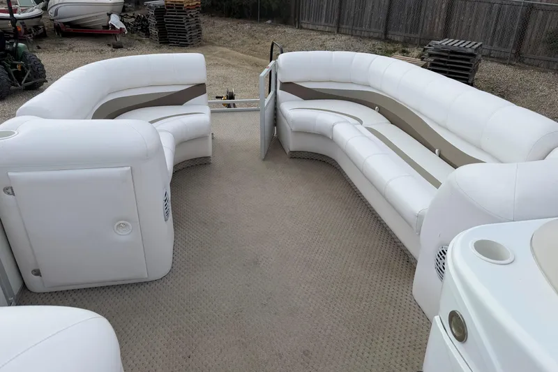 Slide: The Image of 2006 Crest II LE 2270 pontoon boat interior with white seating and carpeted floor. - 9