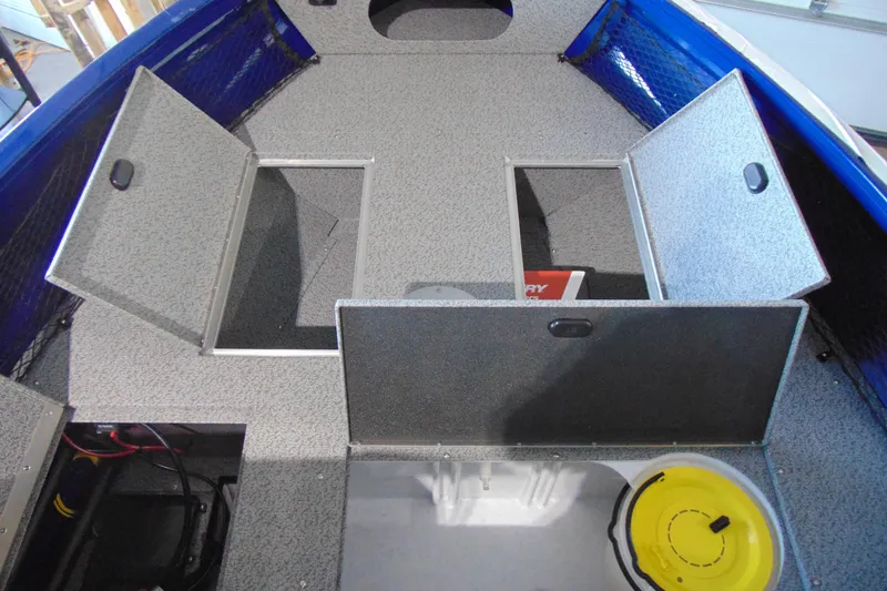 Slide: The Image of 2026 Crestliner 1850 Kodiak WT boat interior with open storage compartments. - 12