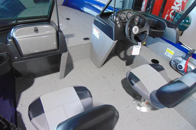 Slide: The Image of 2026 Crestliner 1850 Kodiak WT boat interior with steering wheel and seating. - 8