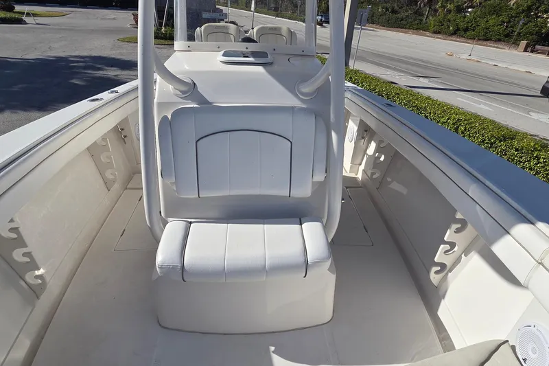 Slide: The Image of 2015 Jupiter 30 FS boat interior with white seating and rod holders. - 13