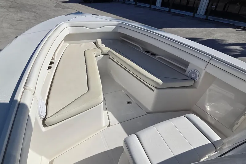 Slide: The Image of 2015 Jupiter 30 FS boat interior with cushioned seating and speaker system. - 16